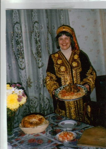 Sarah Chandler provided this picture of her taken December, 1999 in Tashkent, Uzbekistan. At the end of 3 month training the trainers assignment, showing off Plov prepared by law student colleagues, wearing traditional bridal robe and hat, gifts of the Ce